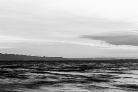 Close view of moving waves on a lake at duskの写真素材