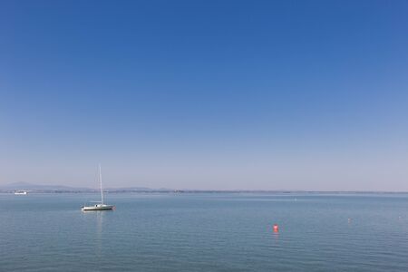 Small boat sailing on Trasimeno lake, Italyの写真素材