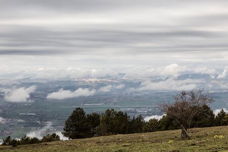 View from above of Umbria valley, with cloudscape both above and below