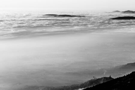 A view from above of Assisi town (Umbria, Italy) in the middle of mist.の写真素材
