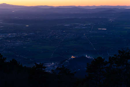 Aerial view of Umbria, Italy, valley at night, with Assisi town in the foreground