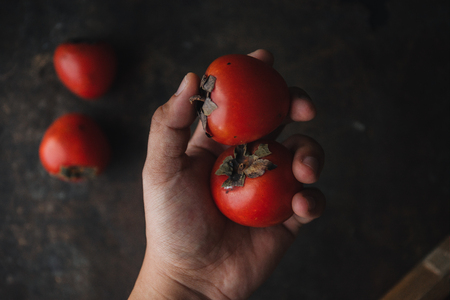 Ripe persimmon on rustic backgroundの写真素材