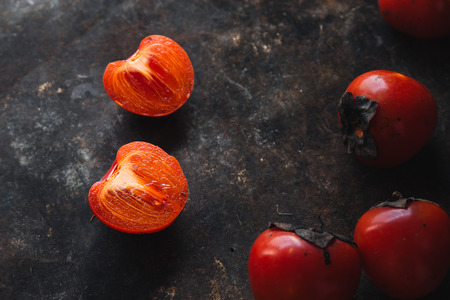 Ripe persimmon on rustic backgroundの写真素材
