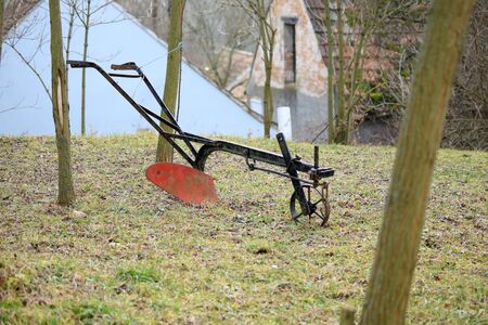 Agricultural old manual plow on grass.