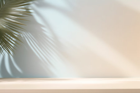 Light beige studio background with shadow from palm leaves on the wall. Rays of the sun on the wall. Minimal studio background for product presentations. Spring and summer.の素材