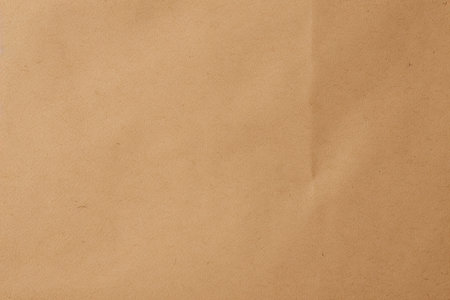 Brown paper background. Beige cardboard texture. Wallpaper. Dark beige wrapping paper backgroundの写真素材