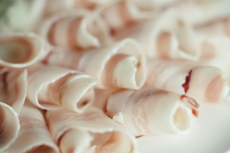 Sliced lard on a white dishの写真素材