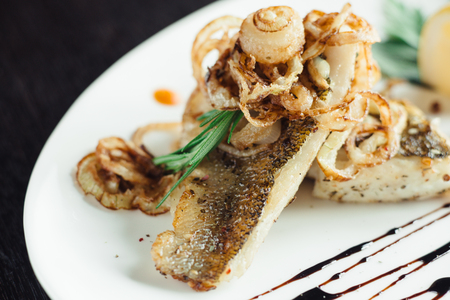 Grilled mackerel with onion plate on wooden tableの写真素材