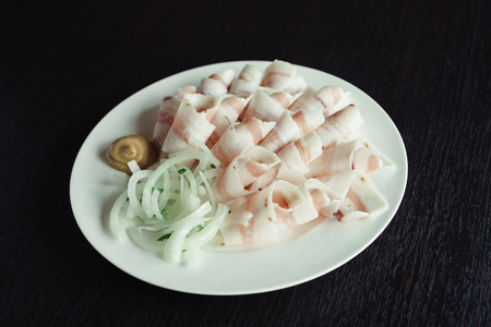 Sliced lard on a white dishの写真素材