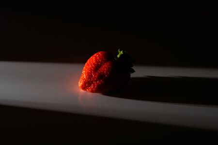 Fresh organic strawberries isolated on a black background. Packaging made from organic strawberries.の写真素材