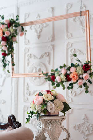 Wooden frame decorated with artificial flowers. wedding composition. Flowers on a stand.の写真素材