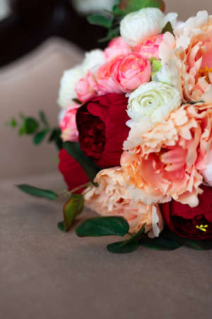 A bouquet of non-real flowers. artificial peonies. Eucalyptus in a bouquetの写真素材