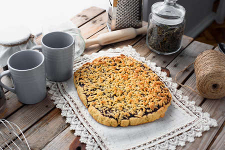 Blue cups and homemade pie on a wooden table. Delicious fruit pie.