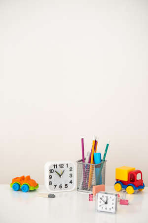 Clock, typewriter and iron glass with pencils. The concept of time is learning.の写真素材