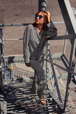 a young girl climbs the steps and looks away. Believe in yourself conceptの写真素材