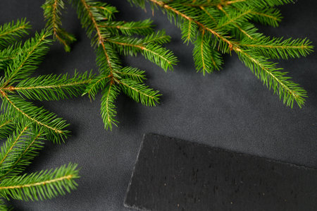 Closeup of an empty slate on a dark table. Kitchen Utensils on the Christmas Table. top view, copy...