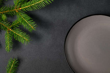 Christmas card with Christmas tree and an empty gray plate. Background for Christmas Advertising. right above. copyspace.の写真素材