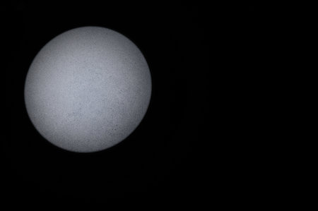 Black Background with Round Beam of Light on Left Side. copyspace. Gray Textured Background.の写真素材