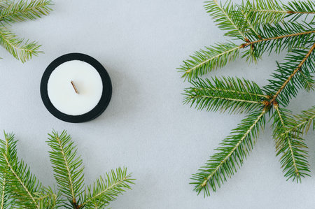 Flat Layout. Top View of Wax Candles in Black Plaster Planter. Candles Handmade. Fir Branches on Table.の写真素材