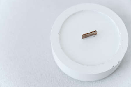Soy Candle in White Round Gypsum Candlestick. top view. wooden wick. New Candle. Concept of Warmth...