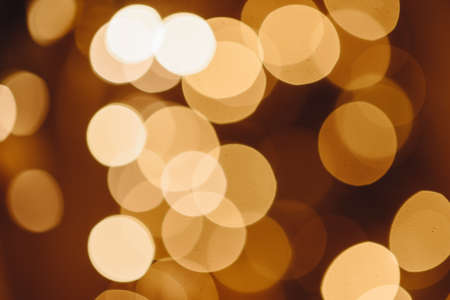 Circles of Bright Lights in Dark. Black Background with Golden Light Effects. Horizontal Background...
