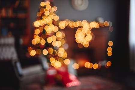 Festively Decorated Room in Soft Focus Christmas Tree, Taken for Photo Background. Blurred Image of Christmas Room. Golden Bokeh Interior.の写真素材