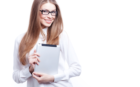 Young woman with digital tablet computer PC isolated on white background wearing white business shirt and glassesの写真素材