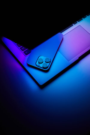 Laptop with smartphone. Neon dark light. Technology, internet business conceptの写真素材
