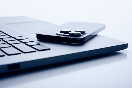 Laptop with smartphone. Close up image.の写真素材
