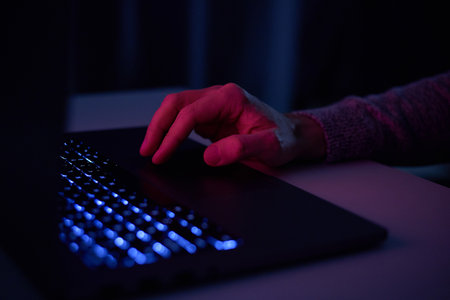 Male hands are typing on a laptop keyboard. A man works, develops a business, studies, plays a...