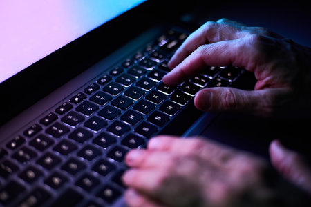 Male hands are typing on a laptop keyboard. A man works, develops a business, studies, plays a...
