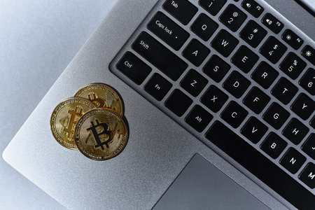 Gold bitcoin coins, laptop keyboard close up. Cryptocurrency business conceptの写真素材