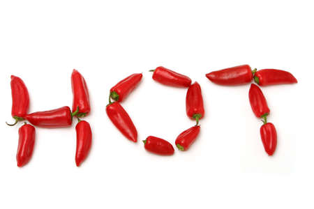 Red peppers spelling hotの写真素材