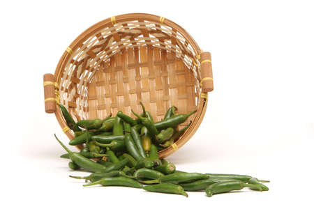 Green chili peppers in a basketの写真素材
