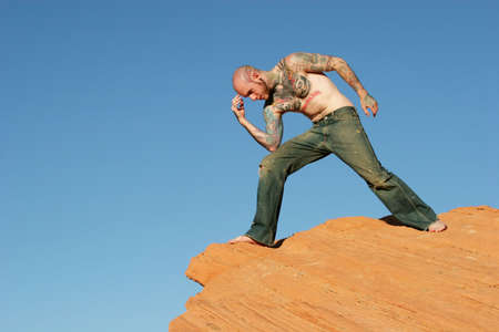 Thinking man on red rocksの写真素材