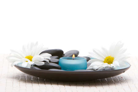 Massage stones and daisiesの写真素材