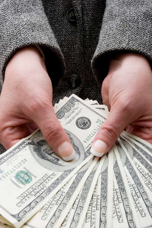 Businesswoman holding hundred dollar bills