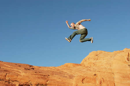 Jumping on red rocksの写真素材