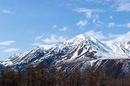 Snow melting on mountains in Alaskaの写真素材