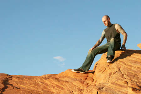 Man on top of red rocksの写真素材