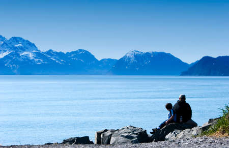 Man and a child viewing the sceneryの写真素材