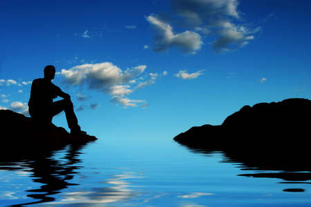 Silhouette of a man on mountain topの写真素材