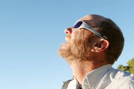 Man looking at the sunの写真素材