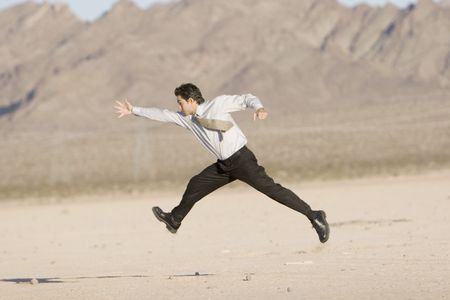 Happy businessman jumping in airの写真素材
