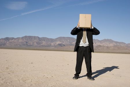 Businessman with a box over his headの写真素材