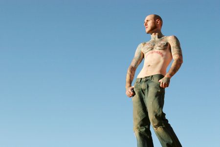 Man with tattoos on his chest and armsの写真素材