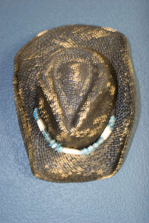 Cowboy hat hanging on the wallの写真素材