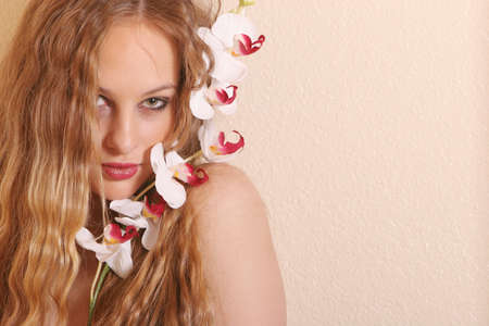 Sexy young blond woman with flowerの写真素材