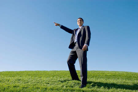 Businessman in dark suit pointing with his fingerの写真素材