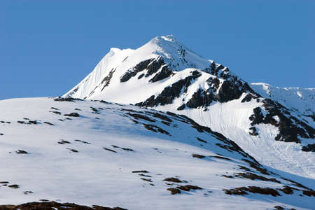 Snow covered mountain peaks during winterの写真素材